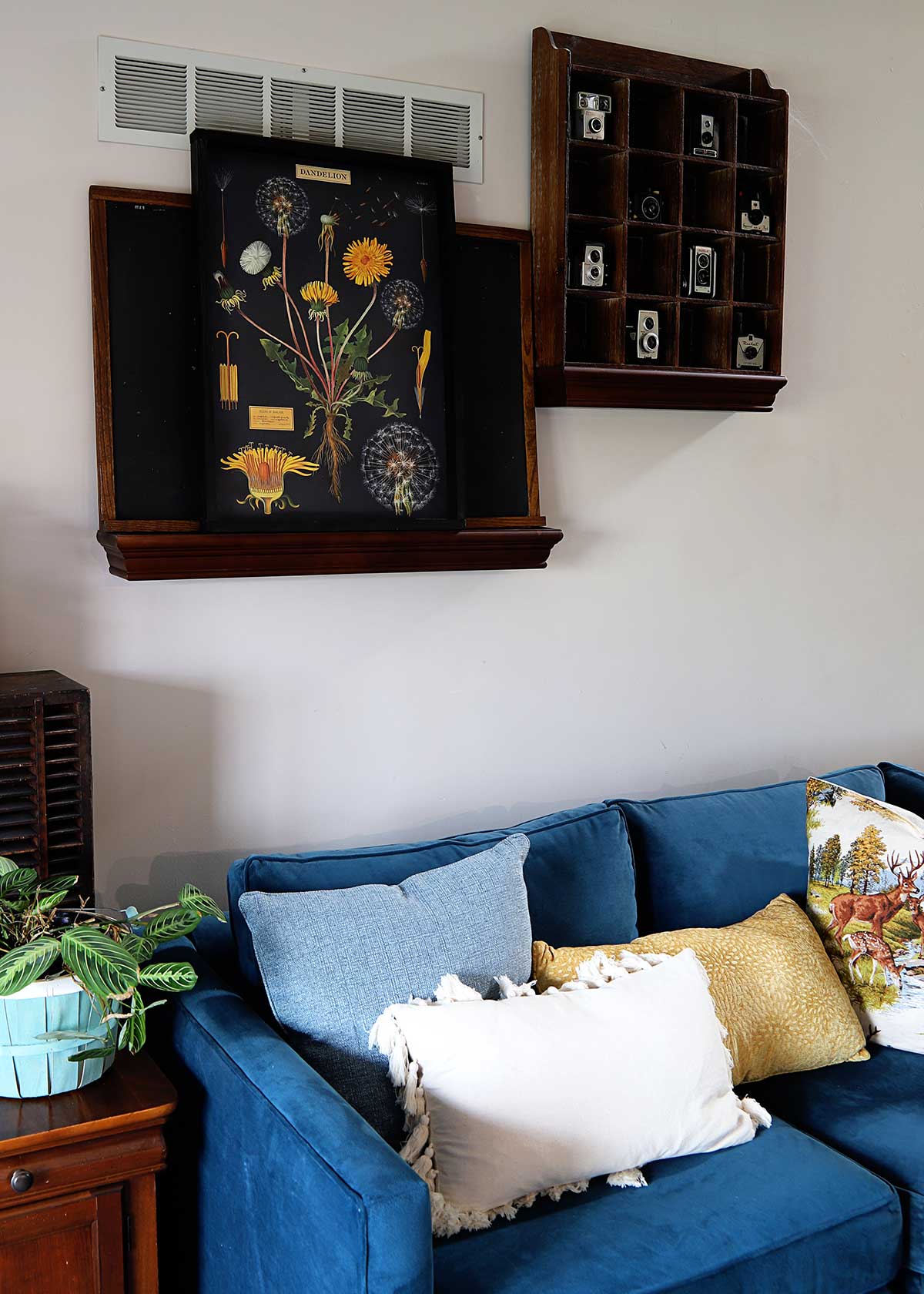 living room with bright blue sofa and artwork made from a poster and a DIY wood poster frame 