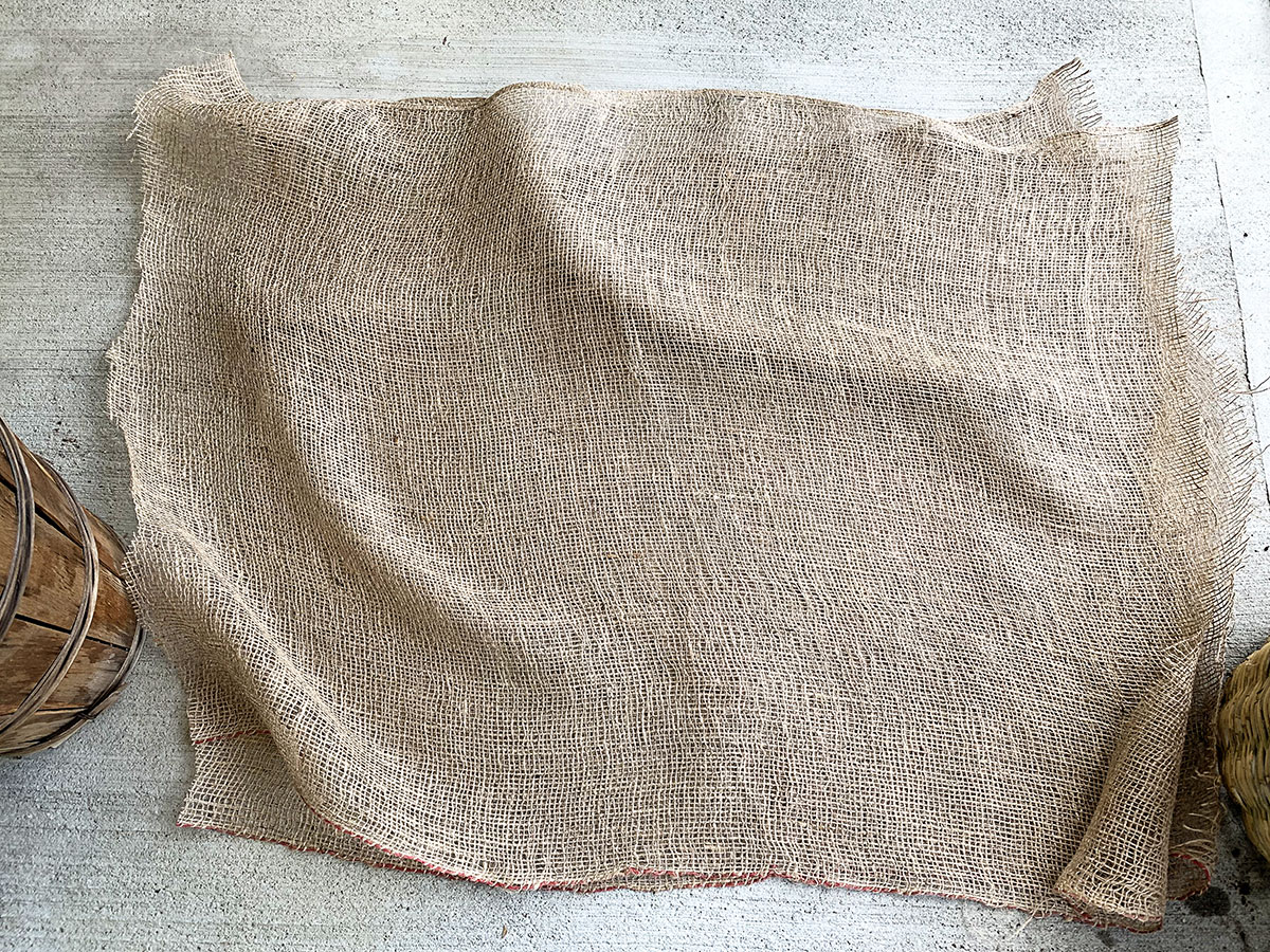 Two pieces of burlap cut from the roll of garden burlap.
