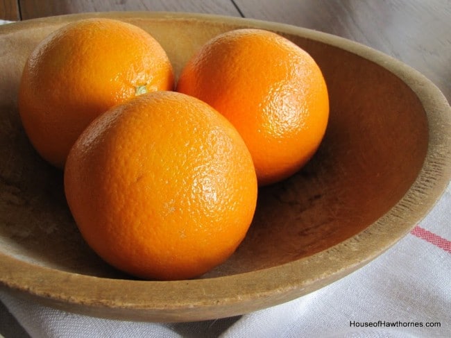 Three oranges in a bowl.