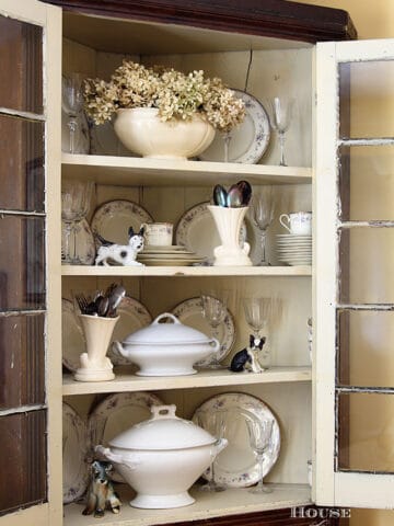Corner cupboard filled with ironstone