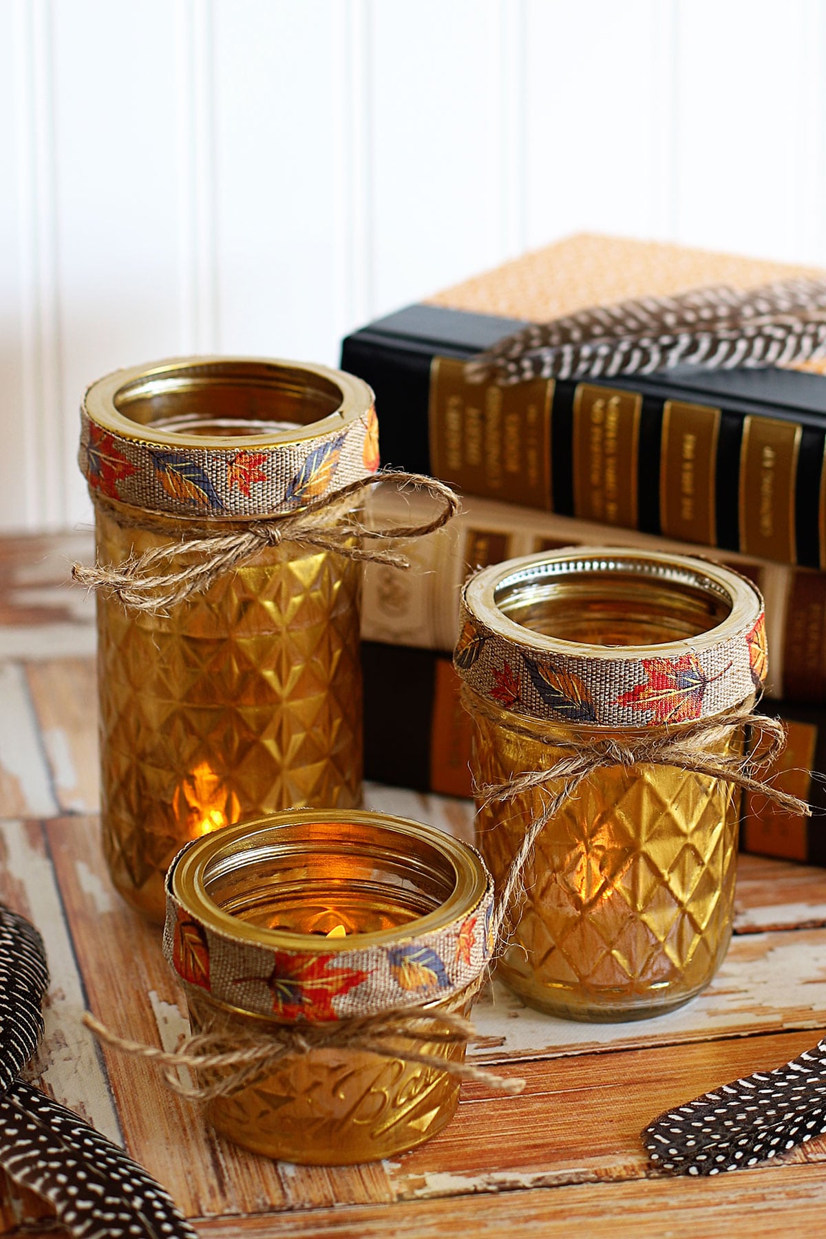 Mason jars painted gold and used as candle holders.