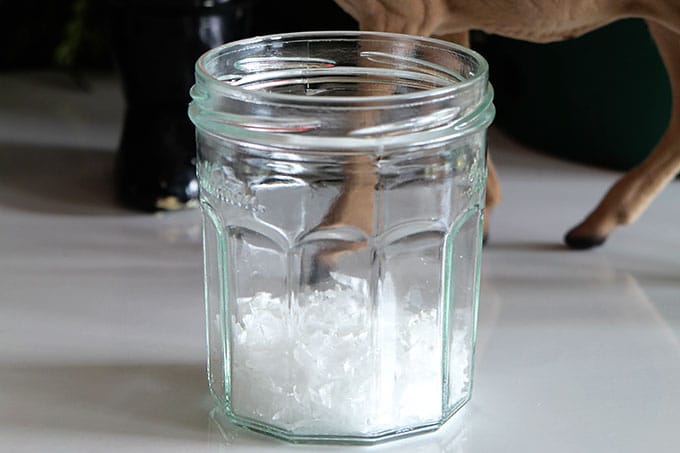 Buffalo snow in a glass jelly jar in order to make a snow globe. 