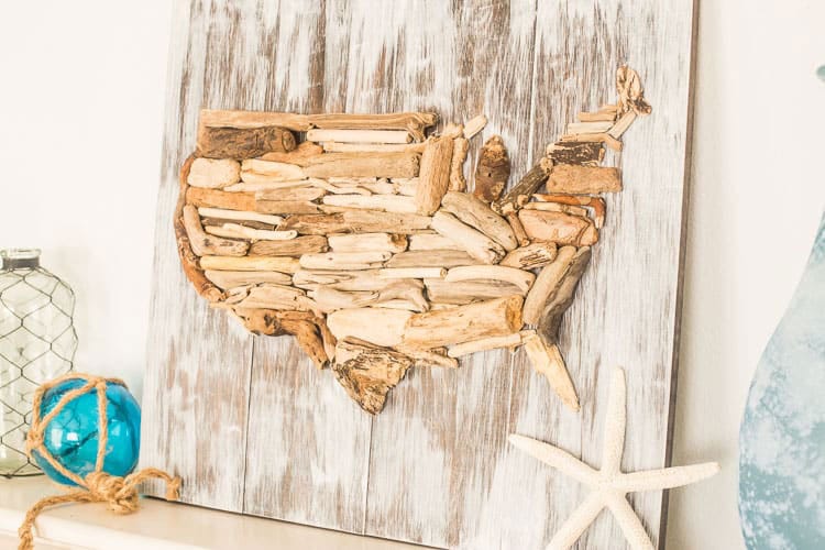 DIY driftwood flag on a white wooden background.