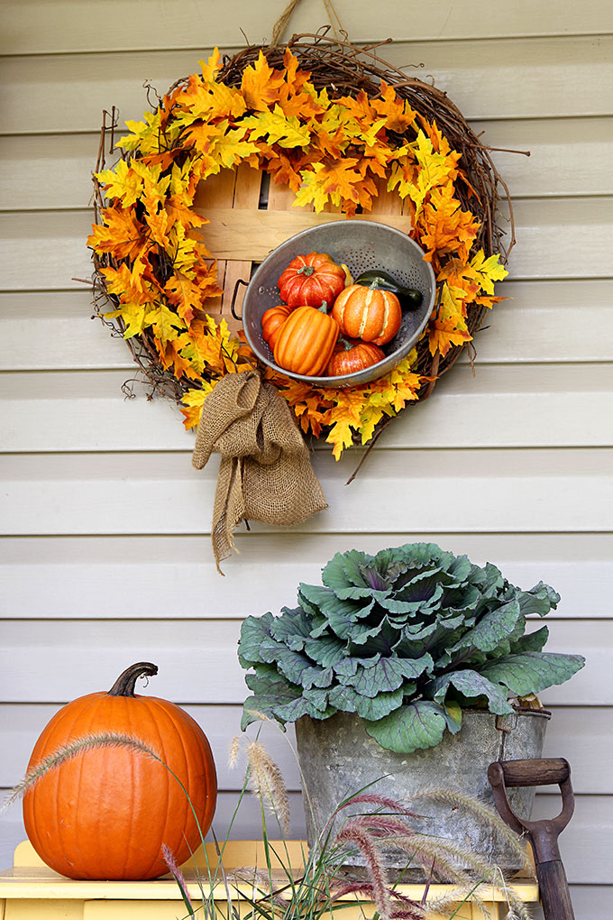 DIY fall wreath with leaves and pumpkins.