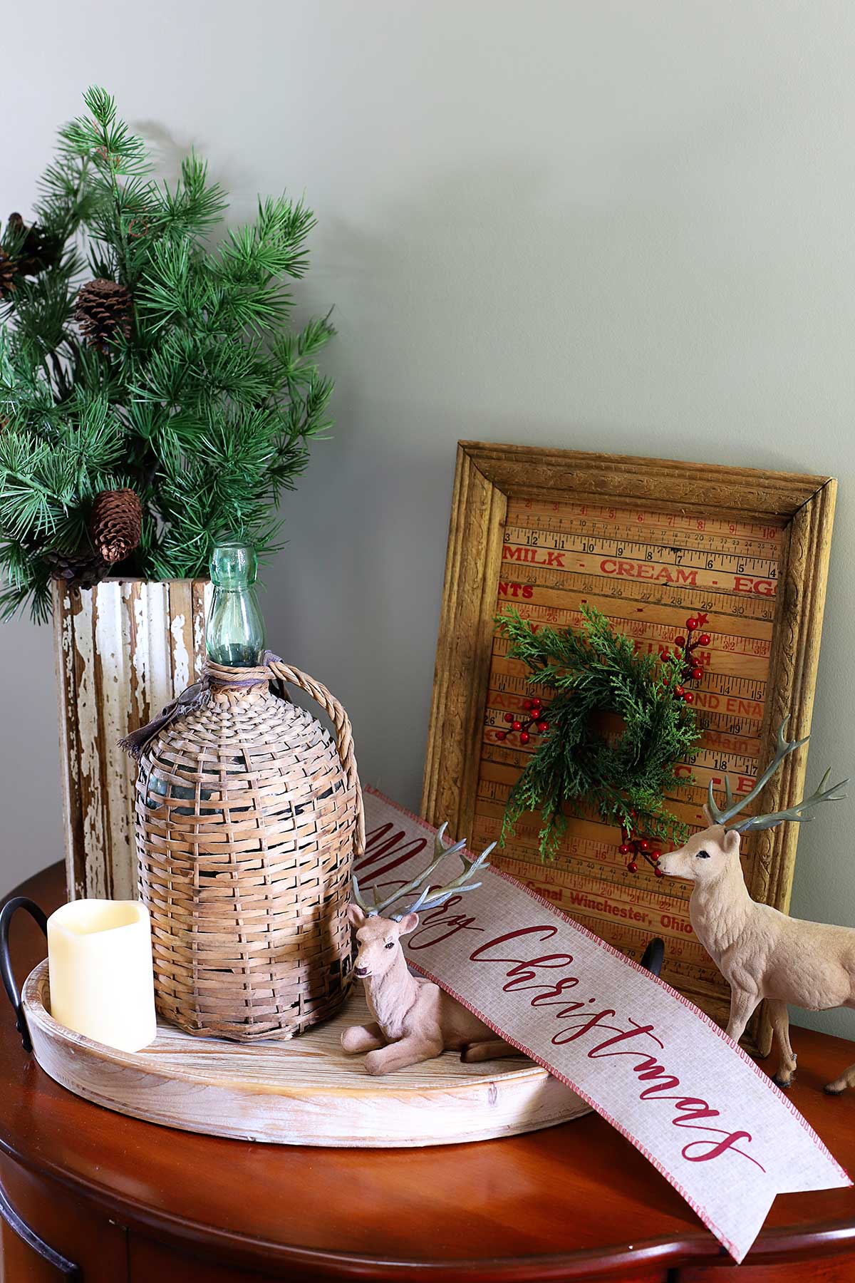French country Christmas vignette with deer and demijohn