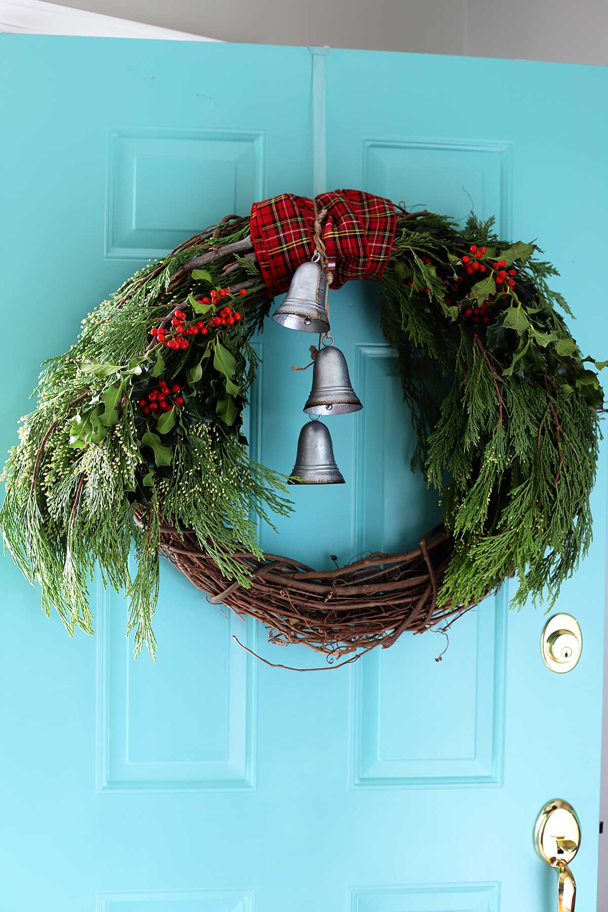 Easy to make winter wreath made with cedar boughs and holly