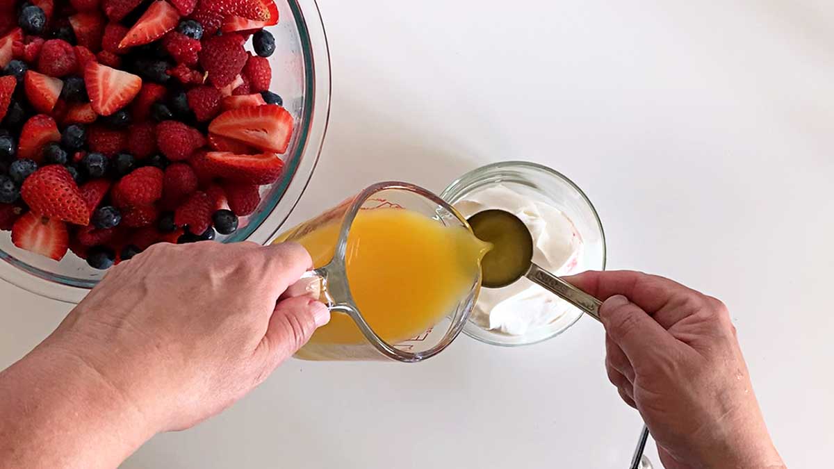 Pouring orange juice into sour cream.