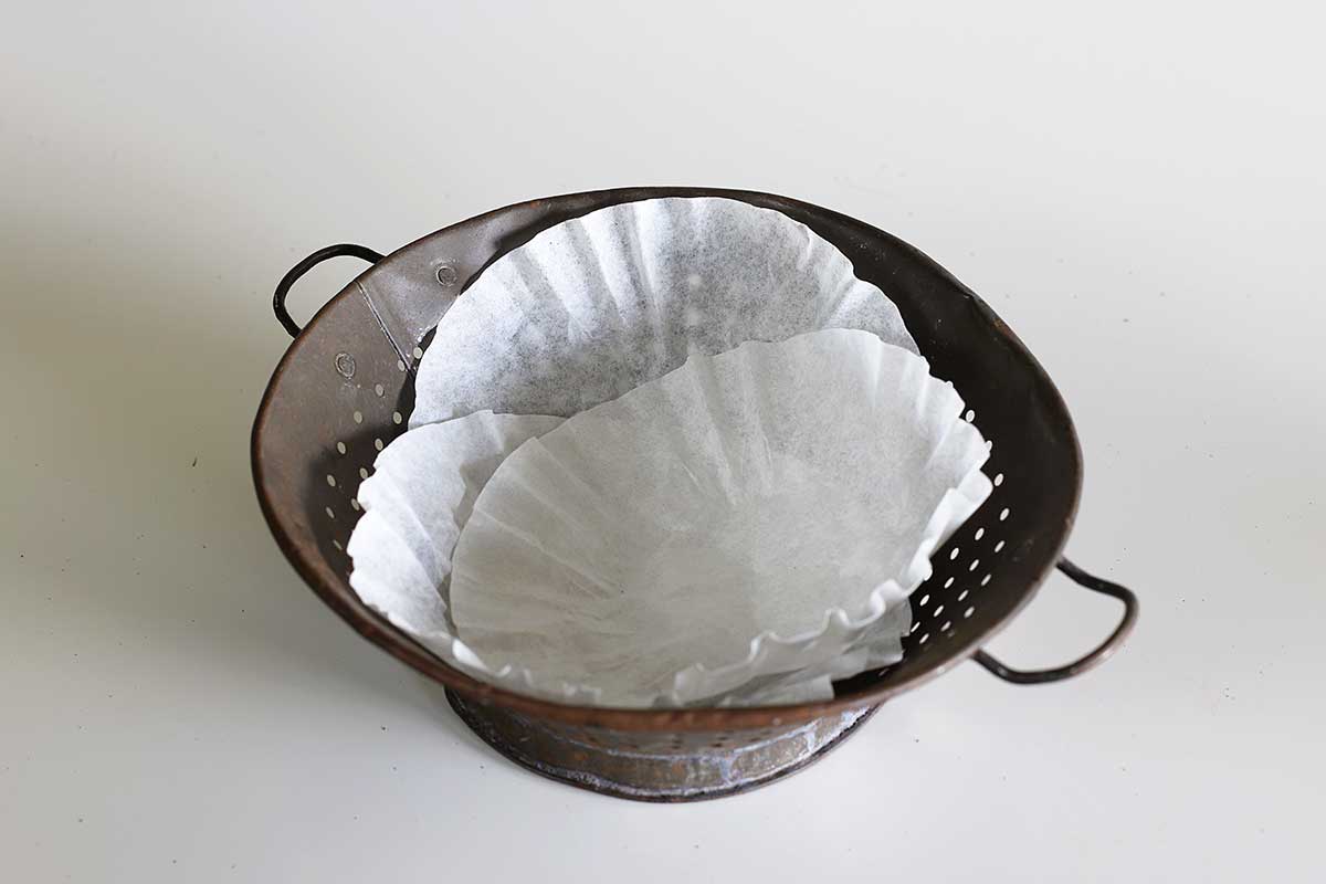using coffee filters to line colander for planting