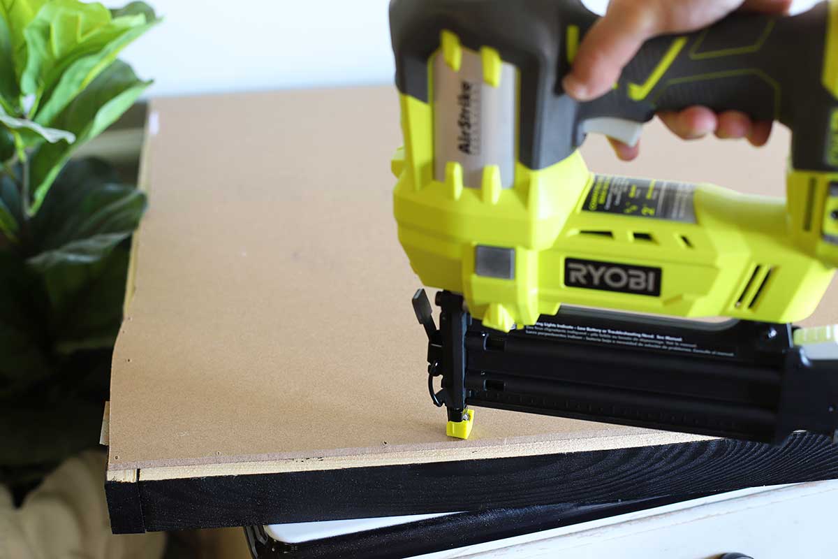 attaching poster to wood frame with brad nailer