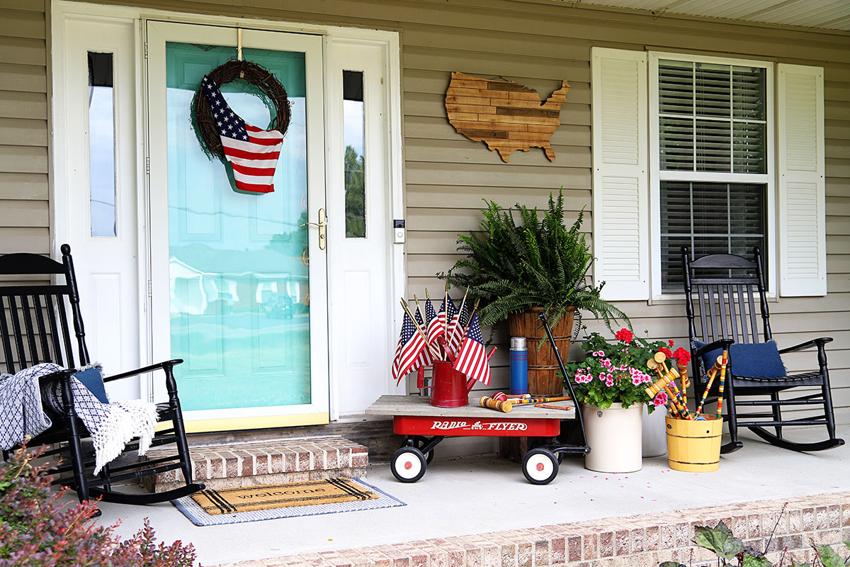 Porch decorated for the summer holidays - 4th Of July, Memorial Day and Labor Day. Decorated using vintage items, plants and flags. 