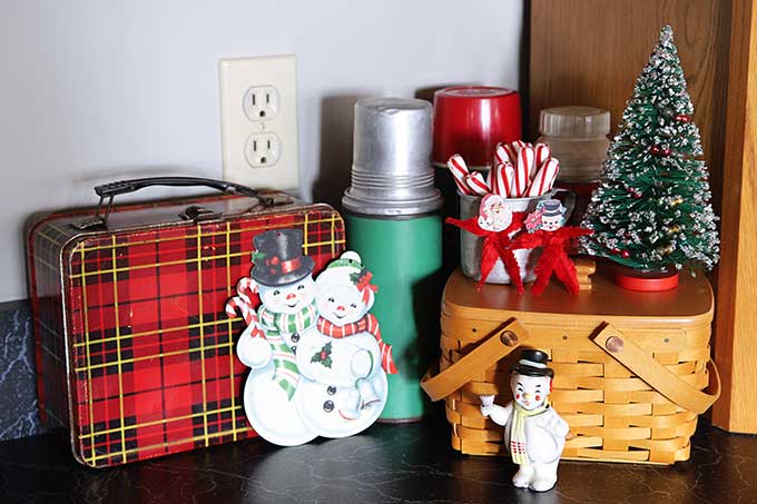 Vintage lunchboxes and thermoses used as Christmas decor