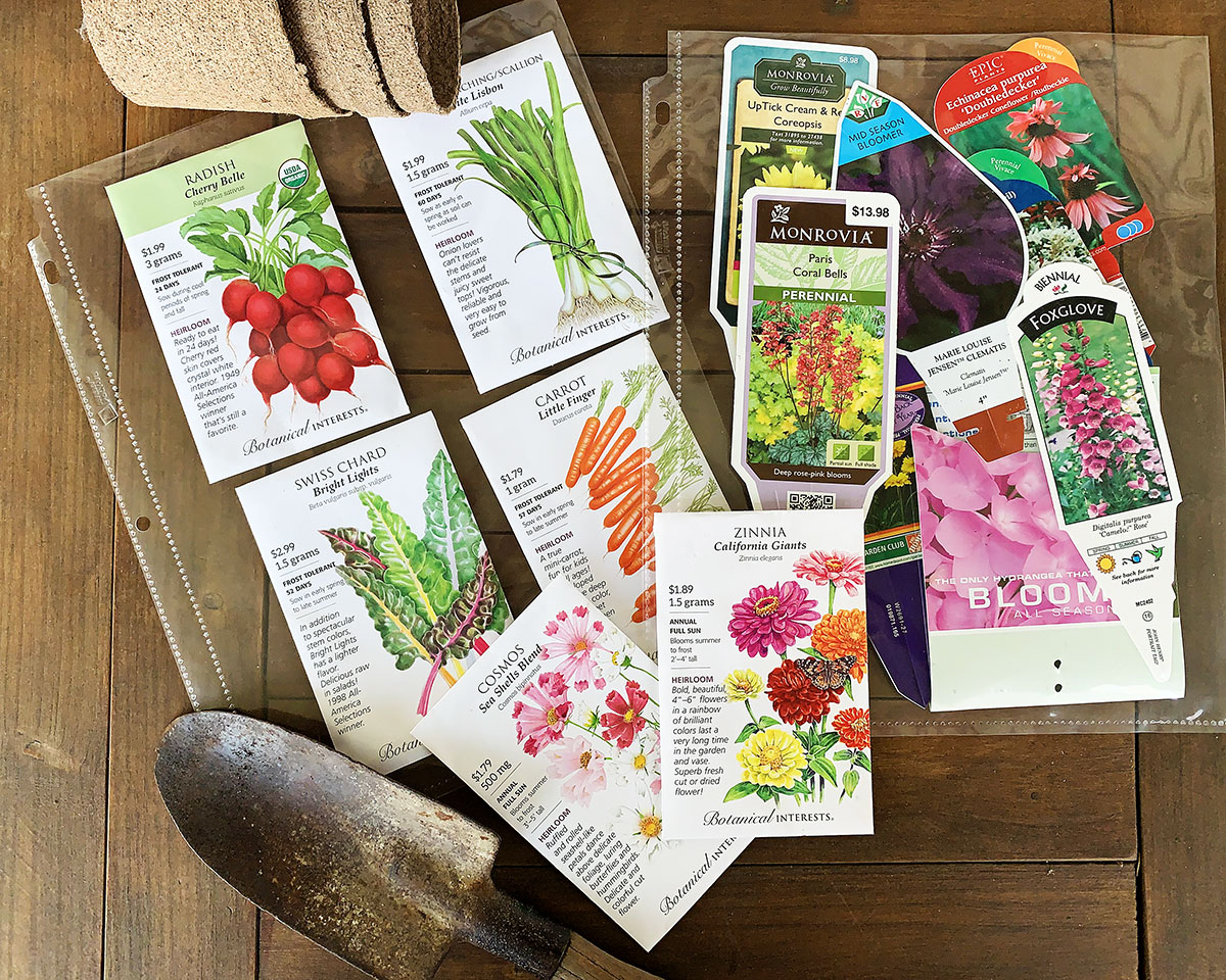 seed packets and plant tags in plastic sleeves for 3 ring binder - garden planner organization