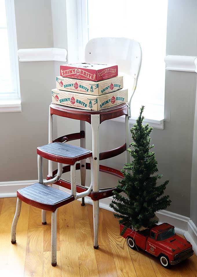 Vintage Shiny Brite boxes on a vintage Cosco step stool