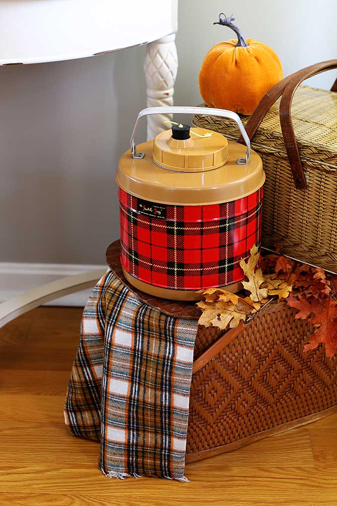 Vintage thermos and picnic basket used as fall decor