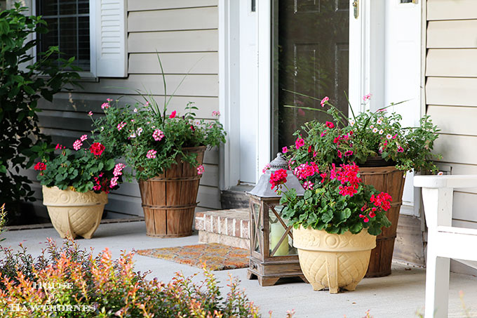 Summer porch decorating ideas and inspiration using farmhouse touches, vintage items, plenty of annual flowers and a healthy dose of patriotic decor. 