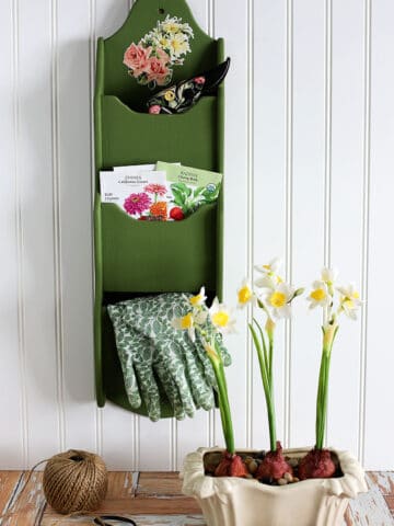 Upcycled garden tool organizer made from a wooden mail organizer from the 1970's.