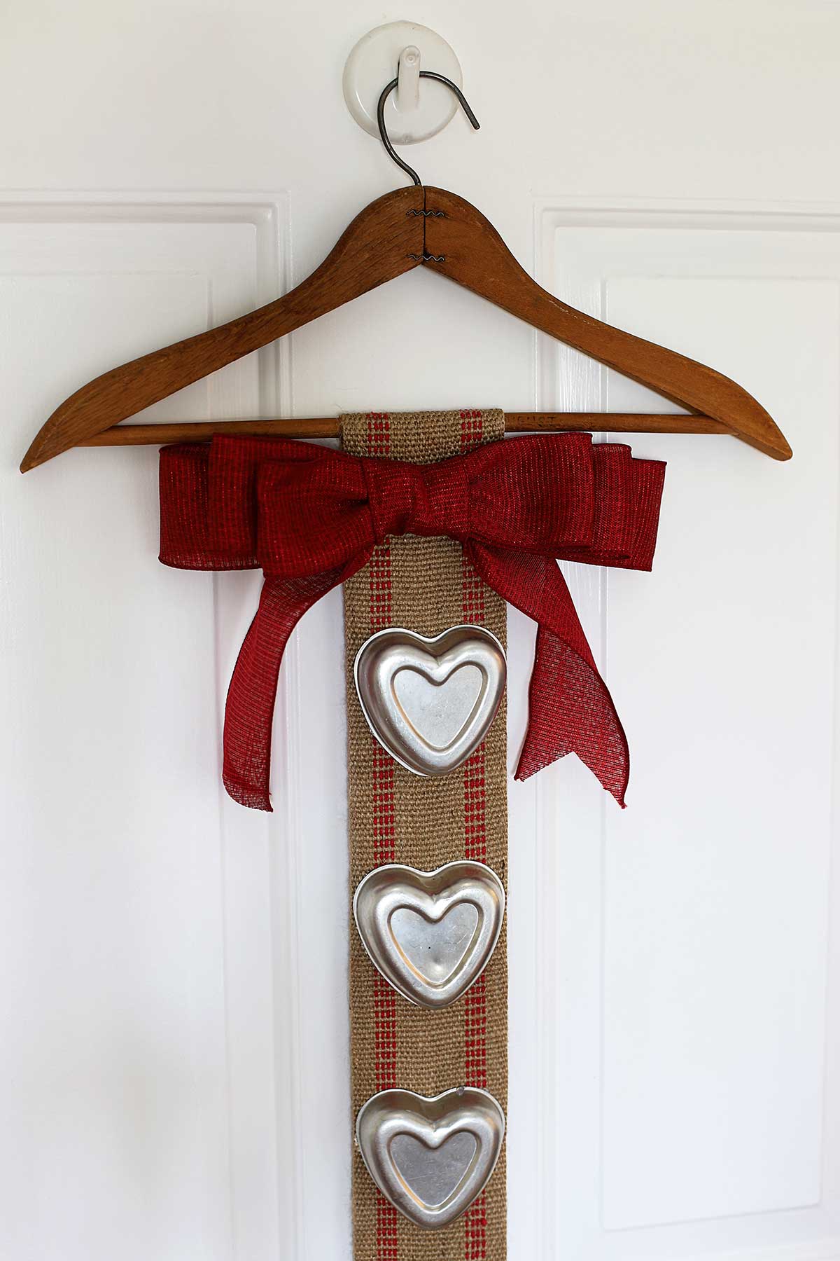 Upcycled Valentines Day banner using upholstery webbing and vintage tin heart jello molds