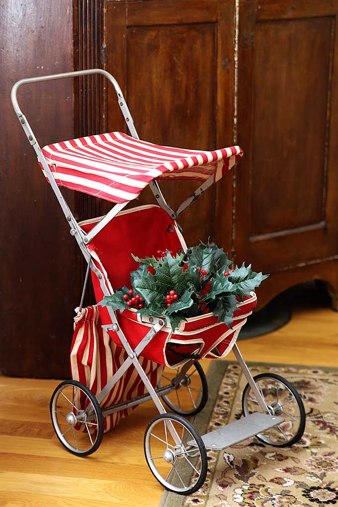Vintage doll stroller decorated for Christmas