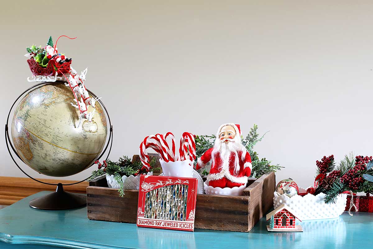 red Santas and candy canes mixed in with a collection of milk glass 