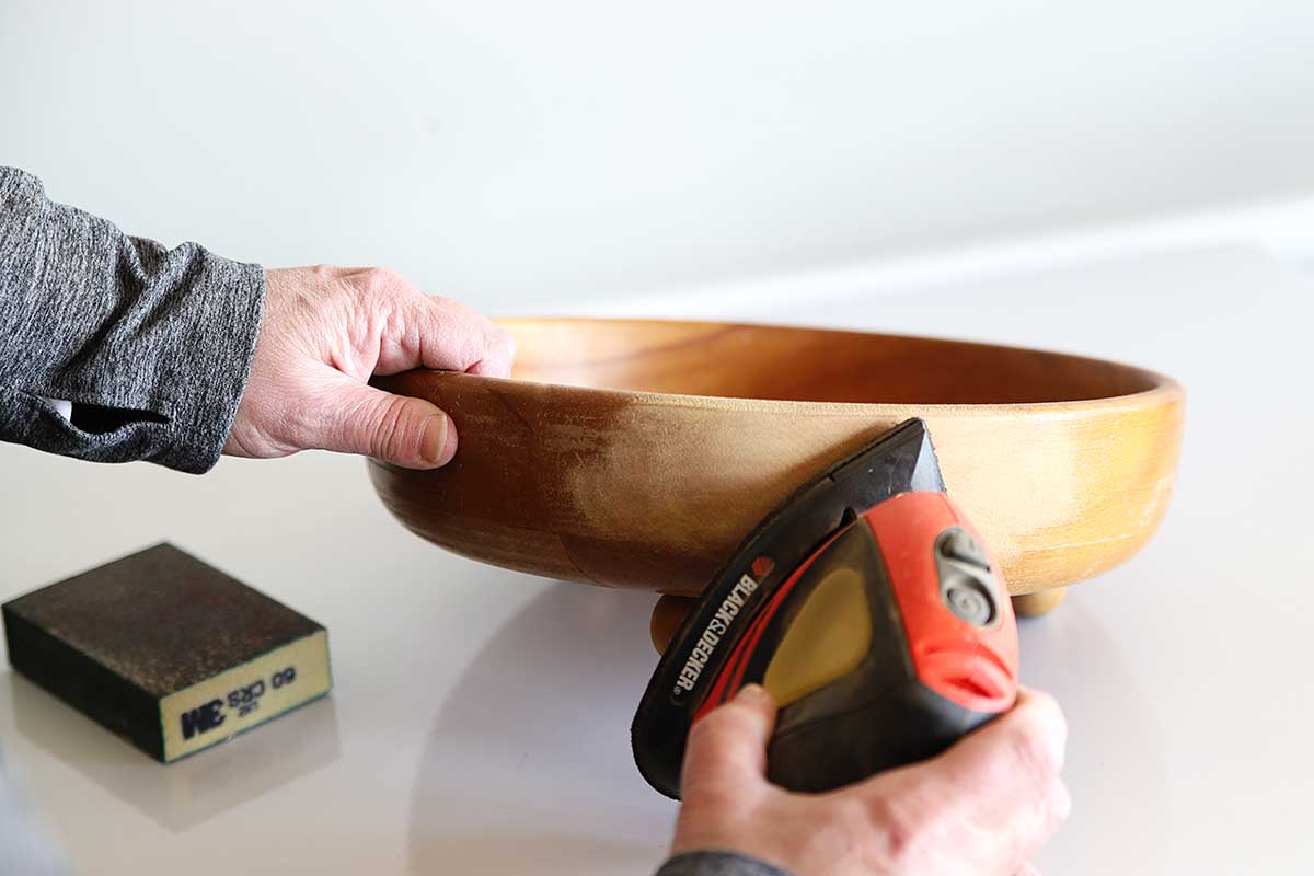 Sanding wooden bowl to prepare for bleaching
