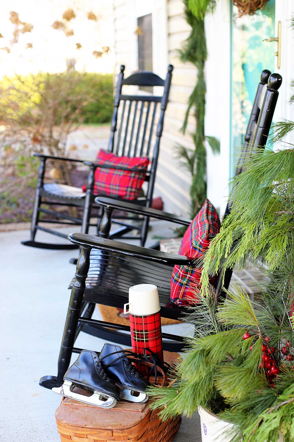 black rockers on the porch decorated for Christmas